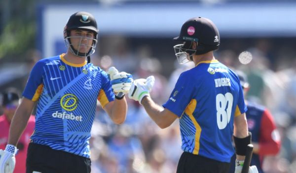 Tom Clark bats with Dan Hughes