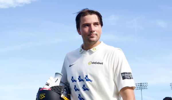 James Coles acknowledges supporters as he walks off after hitting a double century against Glamorgan