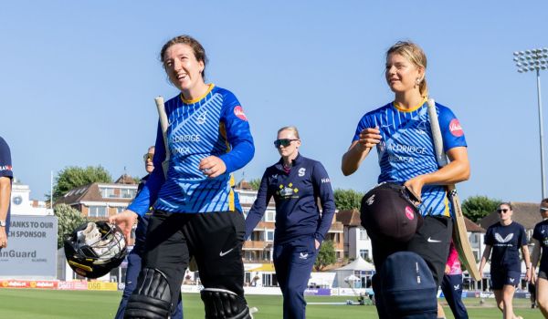Phoebe Wilkinson and Bella Johnson walking off the field after victory against Northants Steelbacks.
