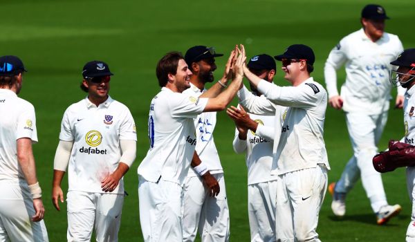 Sussex squad celebrating a wicket.