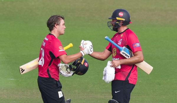 Charlie Tear celebrates his century with Jack Leaning