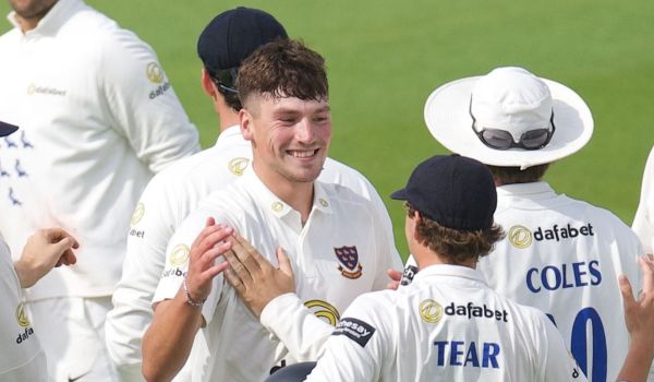 Henry Crocombe celebrates his five-fer with his teammates.
