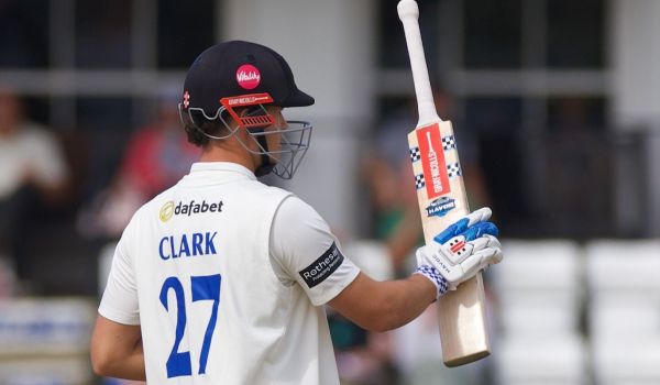 Tom Clark raises his bat for his fifty.